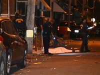 The crime scene unit is at the scene of a mass shooting with evidence markers placed on the ground, in Philadelphia, Pennsylvania, on July 2...