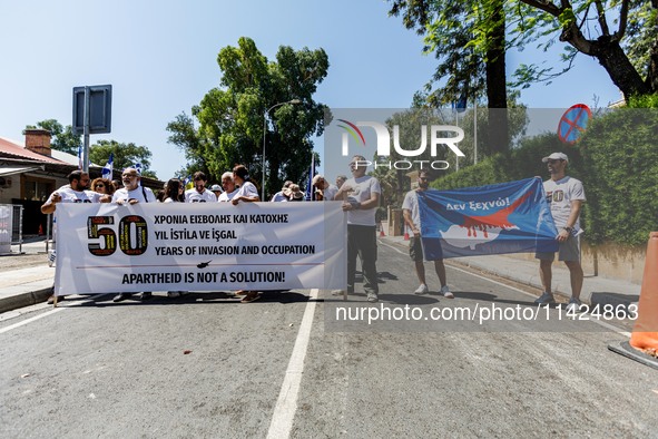 A group of Greek-Cypriots and Turkish-Cypriots is gathering at the Ledra Palace checkpoint to protest about the situation in Cyprus, demandi...