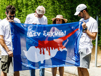 A group of Greek-Cypriots and Turkish-Cypriots is holding a bloodied Cyprus flag reading ''I don't forget,'' gathered at the Ledra Palace ch...