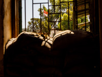 The flags of Turkey and the self-declared ''Turkish Republic of Northern Cyprus'' are being seen through a window of an abandoned house, whi...