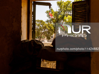 The flags of Turkey and the self-declared ''Turkish Republic of Northern Cyprus'' are being seen through a window of an abandoned house, whi...