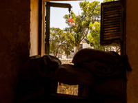 The flags of Turkey and the self-declared ''Turkish Republic of Northern Cyprus'' are being seen through a window of an abandoned house, whi...