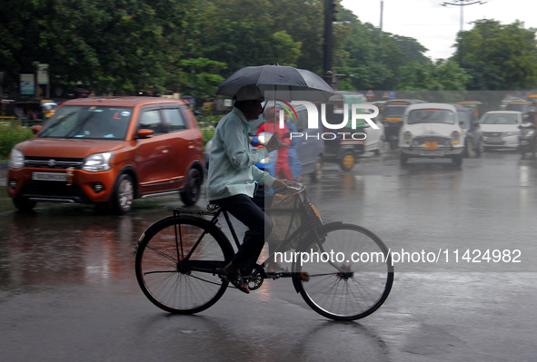 Commuters are being seen on the road as monsoon depression rain lashes in Bhubaneswar, Odisha, India. A deep depression is forming in the Ba...