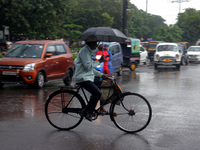 Commuters are being seen on the road as monsoon depression rain lashes in Bhubaneswar, Odisha, India. A deep depression is forming in the Ba...