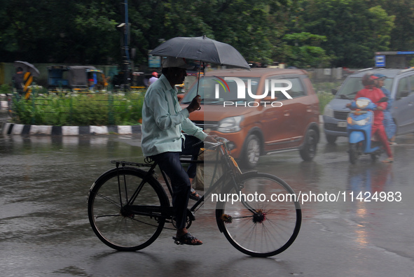 Commuters Are Seen On The Road As Monsoon Depression Rain Lashes In The Eastern Indian State Odisha's Capital City Bhubaneswar. A Deep Depre...