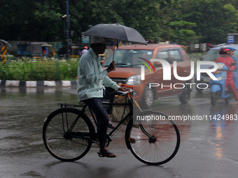 Commuters Are Seen On The Road As Monsoon Depression Rain Lashes In The Eastern Indian State Odisha's Capital City Bhubaneswar. A Deep Depre...