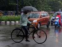 Commuters Are Seen On The Road As Monsoon Depression Rain Lashes In The Eastern Indian State Odisha's Capital City Bhubaneswar. A Deep Depre...