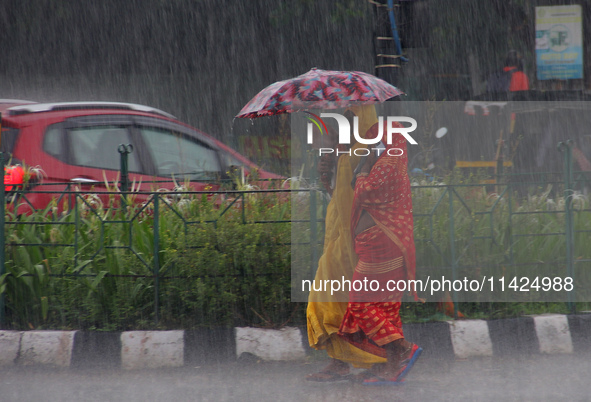 Commuters Are Seen On The Road As Monsoon Depression Rain Lashes In The Eastern Indian State Odisha's Capital City Bhubaneswar. A Deep Depre...