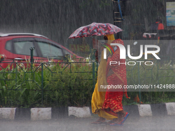 Commuters Are Seen On The Road As Monsoon Depression Rain Lashes In The Eastern Indian State Odisha's Capital City Bhubaneswar. A Deep Depre...