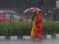 Commuters Are Seen On The Road As Monsoon Depression Rain Lashes In The Eastern Indian State Odisha's Capital City Bhubaneswar. A Deep Depre...