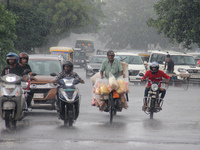 Commuters Are Seen On The Road As Monsoon Depression Rain Lashes In The Eastern Indian State Odisha's Capital City Bhubaneswar. A Deep Depre...