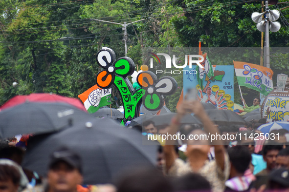 A large cutout of the TMC emblem is being seen during the annual martyrs' day rally held by the TMC party in Kolkata, India, on July 21, 202...