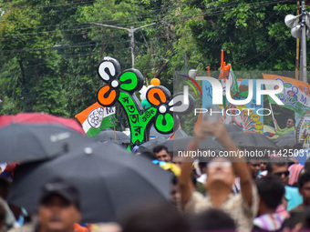 A large cutout of the TMC emblem is being seen during the annual martyrs' day rally held by the TMC party in Kolkata, India, on July 21, 202...