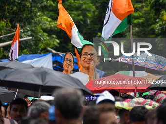 A large cutout of TMC supremo CM Mamata Banerjee is being seen at the annual martyrs' day rally held by the TMC party in Kolkata, India, on...