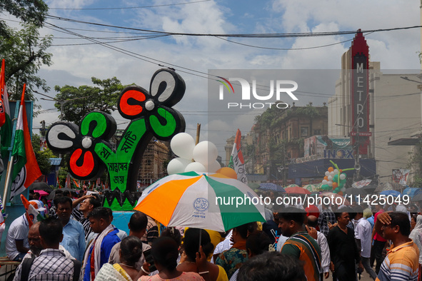 People are attending the annual Martyrs' Day rally held by the TMC party in Kolkata, India, on July 21, 2024. 