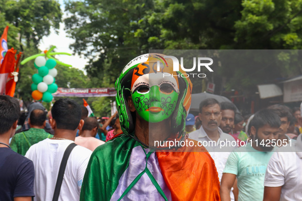 A man is wearing a colored mask during the annual Martyrs' Day rally held by the TMC party in Kolkata, India, on July 21, 2024. 