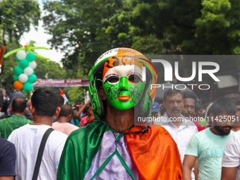 A man is wearing a colored mask during the annual Martyrs' Day rally held by the TMC party in Kolkata, India, on July 21, 2024. (