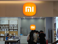 Customers are experiencing two fold-screen phones newly released by Xiaomi at a Xiaomi Home in Shanghai, China, on July 21, 2024. (