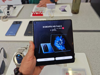 Customers are experiencing two fold-screen phones newly released by Xiaomi at a Xiaomi Home in Shanghai, China, on July 21, 2024. (