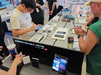 Customers are experiencing two fold-screen phones newly released by Xiaomi at a Xiaomi Home in Shanghai, China, on July 21, 2024. (