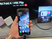 Customers are experiencing two fold-screen phones newly released by Xiaomi at a Xiaomi Home in Shanghai, China, on July 21, 2024. (