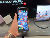 Customers are experiencing two fold-screen phones newly released by Xiaomi at a Xiaomi Home in Shanghai, China, on July 21, 2024. (