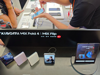 Customers are experiencing two fold-screen phones newly released by Xiaomi at a Xiaomi Home in Shanghai, China, on July 21, 2024. (