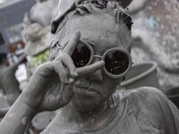 Visitors are playing in a mud pool at Mud Festival Park in Boryeong, South Korea. The Boryeong Mud Festival is an annual festival that takes...