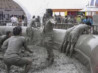 Visitors are playing in a mud pool at Mud Festival Park in Boryeong, South Korea. The Boryeong Mud Festival is an annual festival that takes...