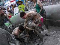 Visitors are playing in a mud pool at Mud Festival Park in Boryeong, South Korea. The Boryeong Mud Festival is an annual festival that takes...