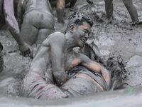 Visitors are playing in a mud pool at Mud Festival Park in Boryeong, South Korea. The Boryeong Mud Festival is an annual festival that takes...