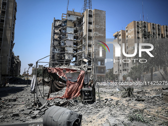 Palestinians are checking the rubble of buildings that were destroyed following an Israeli air strike on a residential building, amid the Is...