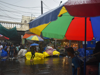 People are walking on the street in the rain in Kolkata, India, on July 21, 2024. (