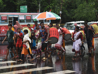 People are walking on the street in the rain in Kolkata, India, on July 21, 2024. (