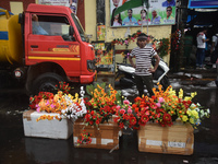 A person is selling plastic flowers during the monsoon in Kolkata, India, on July 21, 2024. (