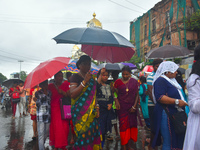 Women are using umbrellas while walking on the street during the monsoon in Kolkata, India, on July 21, 2024. (