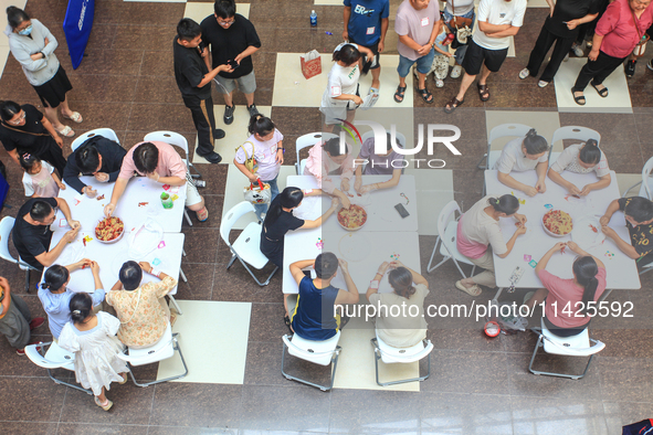 Citizens are taking part in an activity to ''eat shrimp'' at a commercial center in Huai'an city, Jiangsu province, China, on July 21, 2024....