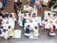 Citizens are taking part in an activity to ''eat shrimp'' at a commercial center in Huai'an city, Jiangsu province, China, on July 21, 2024....