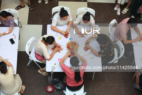 Citizens are taking part in an activity to ''eat shrimp'' at a commercial center in Huai'an city, Jiangsu province, China, on July 21, 2024....