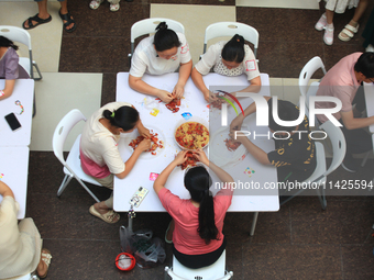 Citizens are taking part in an activity to ''eat shrimp'' at a commercial center in Huai'an city, Jiangsu province, China, on July 21, 2024....