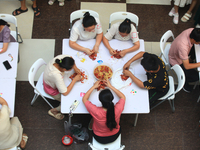 Citizens are taking part in an activity to ''eat shrimp'' at a commercial center in Huai'an city, Jiangsu province, China, on July 21, 2024....