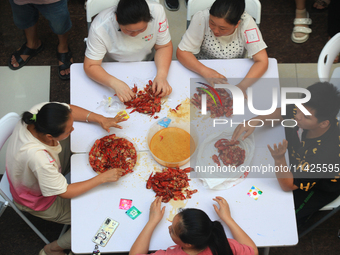 Citizens are taking part in an activity to ''eat shrimp'' at a commercial center in Huai'an city, Jiangsu province, China, on July 21, 2024....