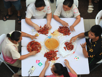 Citizens are taking part in an activity to ''eat shrimp'' at a commercial center in Huai'an city, Jiangsu province, China, on July 21, 2024....