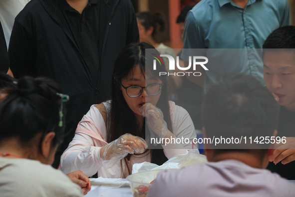 Citizens are taking part in an activity to ''eat shrimp'' at a commercial center in Huai'an city, Jiangsu province, China, on July 21, 2024....