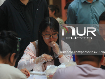 Citizens are taking part in an activity to ''eat shrimp'' at a commercial center in Huai'an city, Jiangsu province, China, on July 21, 2024....