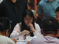 Citizens are taking part in an activity to ''eat shrimp'' at a commercial center in Huai'an city, Jiangsu province, China, on July 21, 2024....