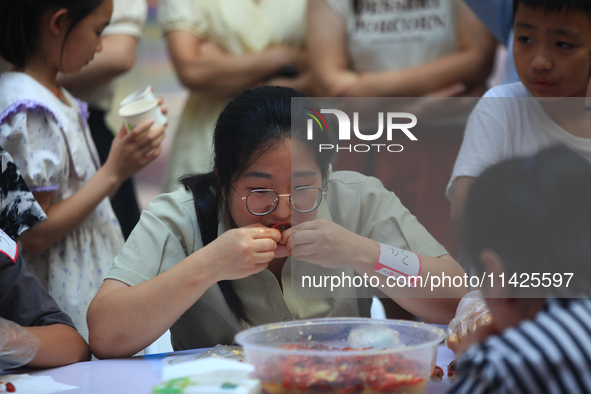 Citizens are taking part in an activity to ''eat shrimp'' at a commercial center in Huai'an city, Jiangsu province, China, on July 21, 2024....