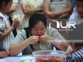 Citizens are taking part in an activity to ''eat shrimp'' at a commercial center in Huai'an city, Jiangsu province, China, on July 21, 2024....