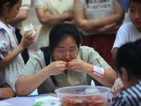 Citizens are taking part in an activity to ''eat shrimp'' at a commercial center in Huai'an city, Jiangsu province, China, on July 21, 2024....