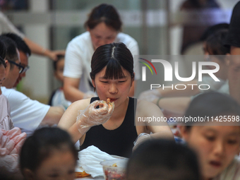 Citizens are taking part in an activity to ''eat shrimp'' at a commercial center in Huai'an city, Jiangsu province, China, on July 21, 2024....